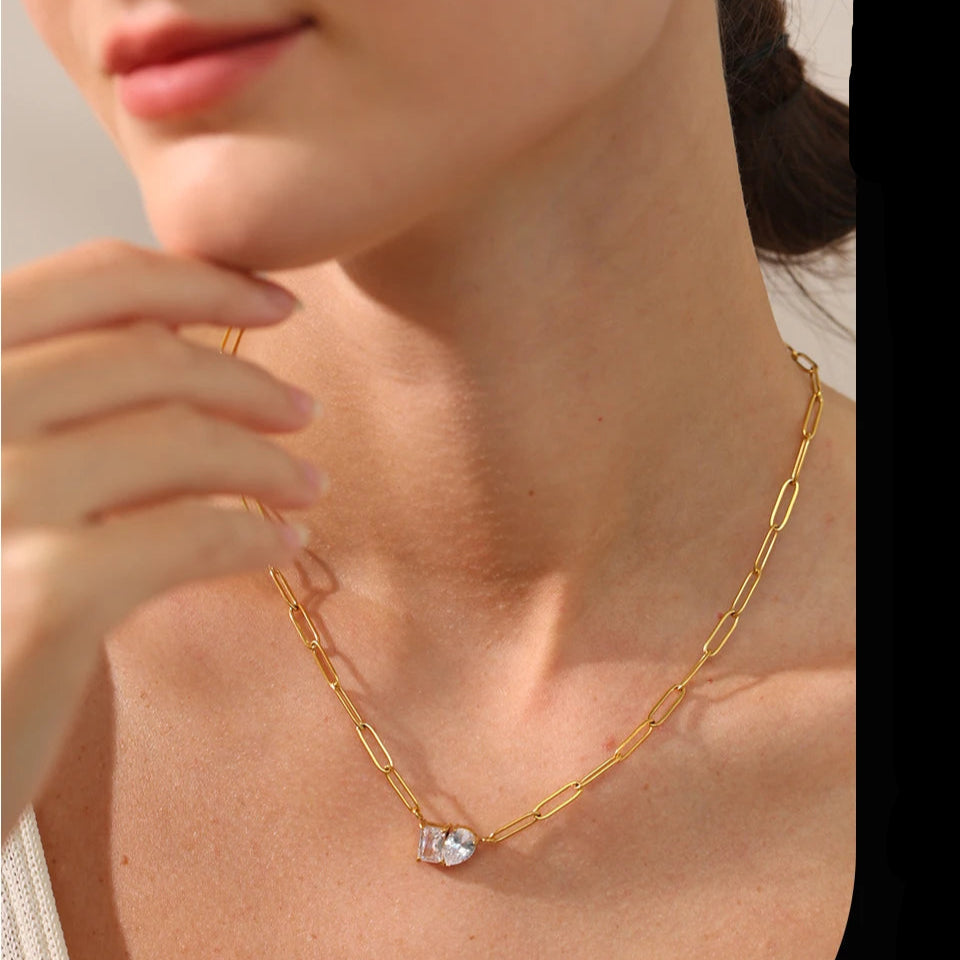 Gold necklace with a small pendant worn by a person