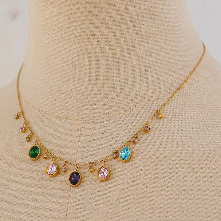 Gold necklace with colorful gemstones on a mannequin neck