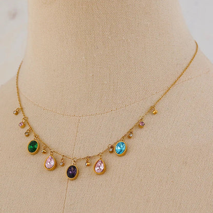Gold necklace with colorful gemstones on a mannequin neck