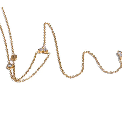 Gold necklace with diamond pendants on a white background